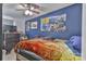A personalized bedroom with blue walls, a ceiling fan, and bedding at 1868 Ellick Dr, Newton, NC 28658