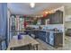 A compact kitchen featuring stainless steel appliances, dark cabinetry, and a breakfast table with seating at 1868 Ellick Dr, Newton, NC 28658