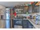 A closer view of the kitchen showcasing stainless appliances and dark wood cabinets at 1868 Ellick Dr, Newton, NC 28658