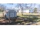 The backyard features a metal storage shed, a chain link fence, and other houses in the background at 206 Mcconnell St, Clover, SC 29710