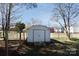 This backyard features a metal storage shed, a chain link fence, a few trees, and an access gate at 206 Mcconnell St, Clover, SC 29710