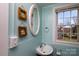 This bathroom has wood trimmed starfish and seashell decorations, a white sink, and a view of the outdoors at 206 Mcconnell St, Clover, SC 29710