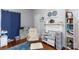This bedroom features a rocking chair, decorations, blue curtains, a bookcase, and a blue patterned rug at 206 Mcconnell St, Clover, SC 29710