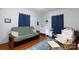 This bedroom features a futon sofa, baby crib, rocking chair, hardwood floor, and a bright patterned rug at 206 Mcconnell St, Clover, SC 29710