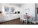 Bright kitchen featuring a dining table with white cabinets and modern appliances at 206 Mcconnell St, Clover, SC 29710