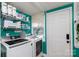 The laundry room features a washer and dryer, storage shelves, a window, and an exterior door to the outside at 206 Mcconnell St, Clover, SC 29710
