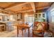 Open dining area connecting the kitchen and screened porch, featuring wooden beam ceilings at 2139 Peninsula Dr, Clover, SC 29710