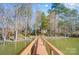 Lakefront property featuring a private wooden dock extending into the water, surrounded by mature trees at 2139 Peninsula Dr, Clover, SC 29710