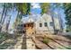 Exterior of home with stairs to screened porch and lake view through the trees at 2139 Peninsula Dr, Clover, SC 29710