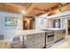 Bright kitchen featuring island seating, a cooktop, stainless steel oven, and wooden beam ceilings at 2139 Peninsula Dr, Clover, SC 29710