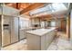 Well-lit kitchen featuring an island, stainless steel refrigerator, light gray cabinets, and wood ceilings at 2139 Peninsula Dr, Clover, SC 29710
