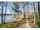 Scenic lake view with a private dock, lush greenery, and a serene walking path along the water's edge at 2139 Peninsula Dr, Clover, SC 29710