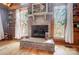 Cozy living room with brick fireplace and large windows offering scenic views at 2139 Peninsula Dr, Clover, SC 29710