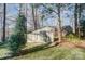 Storage shed on the wooded lot of this lake property with a view of the main house at 2139 Peninsula Dr, Clover, SC 29710