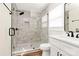 Bathroom featuring modern shower with glass doors, brushed black fixtures, and white marble-look tile at 2159 Greenleaf Rd, Clover, SC 29710
