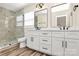 Bathroom featuring double vanity, framed mirrors, a toilet, and glass enclosed shower with marble tile at 2159 Greenleaf Rd, Clover, SC 29710