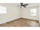 Bedroom with a ceiling fan, two windows, and wood-look flooring in a renovated home at 2159 Greenleaf Rd, Clover, SC 29710