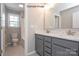 Bathroom featuring a double vanity with gray cabinets, a marble countertop, and brushed gold faucets at 2216 Camber Dr # Cwo0074, Gastonia, NC 28054