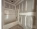 Unfinished bathroom with tub surrounded by drywall walls and bare floors at 2216 Camber Dr # Cwo0074, Gastonia, NC 28054