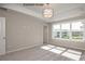 Bedroom showcasing a tray ceiling, natural light, and neutral tones at 2216 Camber Dr # Cwo0074, Gastonia, NC 28054