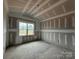 Unfinished bedroom with natural light peering through a window and bare floors at 2216 Camber Dr # Cwo0074, Gastonia, NC 28054