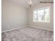 Bright bedroom featuring neutral walls, a large window, and plush carpeted floors at 2216 Camber Dr # Cwo0074, Gastonia, NC 28054