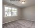 Bedroom with neutral-toned walls, plush carpeting, and a large window for natural light at 2216 Camber Dr # Cwo0074, Gastonia, NC 28054