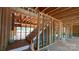 Exposed studs in the entryway showcasing stairs with natural light at 2216 Camber Dr # Cwo0074, Gastonia, NC 28054
