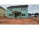 New home under construction with weather resistant wrap, windows installed, and covered back porch at 2216 Camber Dr # Cwo0074, Gastonia, NC 28054