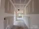 Long hallway under construction, featuring unfinished walls and a view towards a light-filled end at 2216 Camber Dr # Cwo0074, Gastonia, NC 28054