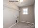 Laundry room features tile floors, utility connections, a window, and shelving at 2216 Camber Dr # Cwo0074, Gastonia, NC 28054