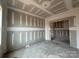 Living room under construction with visible wall studs and concrete flooring, offering a customizable space at 2216 Camber Dr # Cwo0074, Gastonia, NC 28054