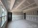 Living room under construction with visible wall studs and concrete flooring and multiple doorways at 2216 Camber Dr # Cwo0074, Gastonia, NC 28054