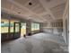 Spacious, unfinished living space with exposed ceiling and studs and large windows providing natural light at 2216 Camber Dr # Cwo0074, Gastonia, NC 28054