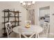 Bright dining area with decorative shelving, white table, and a view to the kitchen at 2937 Bellasera Way, Matthews, NC 28105