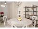 Charming dining area with farmhouse table, decorative shelving and view of front door at 2937 Bellasera Way, Matthews, NC 28105