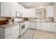 Bright kitchen featuring white cabinets, modern appliances, and tile flooring at 2937 Bellasera Way, Matthews, NC 28105