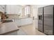 Kitchen with stainless steel refrigerator, white cabinets, and beige tile floors at 2937 Bellasera Way, Matthews, NC 28105