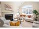 Bright living room features a fireplace, high ceilings, and large windows that let in natural light at 2937 Bellasera Way, Matthews, NC 28105