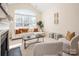 Spacious living room with a cozy fireplace, large windows, and comfortable seating at 2937 Bellasera Way, Matthews, NC 28105