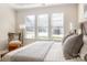 Bedroom with a wood-framed bed and three large windows at 2937 Bellasera Way, Matthews, NC 28105