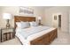Bedroom with a wood-framed bed, side tables, and neutral decor at 2937 Bellasera Way, Matthews, NC 28105