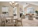 Open-concept layout with a combined dining area, living room with fireplace, and bright kitchen at 2937 Bellasera Way, Matthews, NC 28105