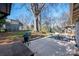 Expansive backyard with mature trees and a patio seating area at 316 S Summit Ave, Charlotte, NC 28208