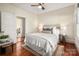 Bedroom with hardwood floors, white bedding, side tables and access to ensuite at 316 S Summit Ave, Charlotte, NC 28208