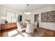 Bright dining room with a modern light fixture and a round wood table surrounded by four upholstered chairs at 316 S Summit Ave, Charlotte, NC 28208