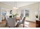 Charming dining room featuring a round table, modern lighting, and a view into the living room at 316 S Summit Ave, Charlotte, NC 28208