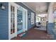 Cozy front porch featuring a swing, seating area, and a vibrant 'HELLO' door mat by the blue front door at 316 S Summit Ave, Charlotte, NC 28208