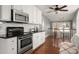 Kitchen with stainless steel appliances, granite countertops, and white cabinetry at 316 S Summit Ave, Charlotte, NC 28208