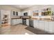 Well-lit kitchen with stainless steel appliances, granite countertops and stylish white cabinets at 316 S Summit Ave, Charlotte, NC 28208